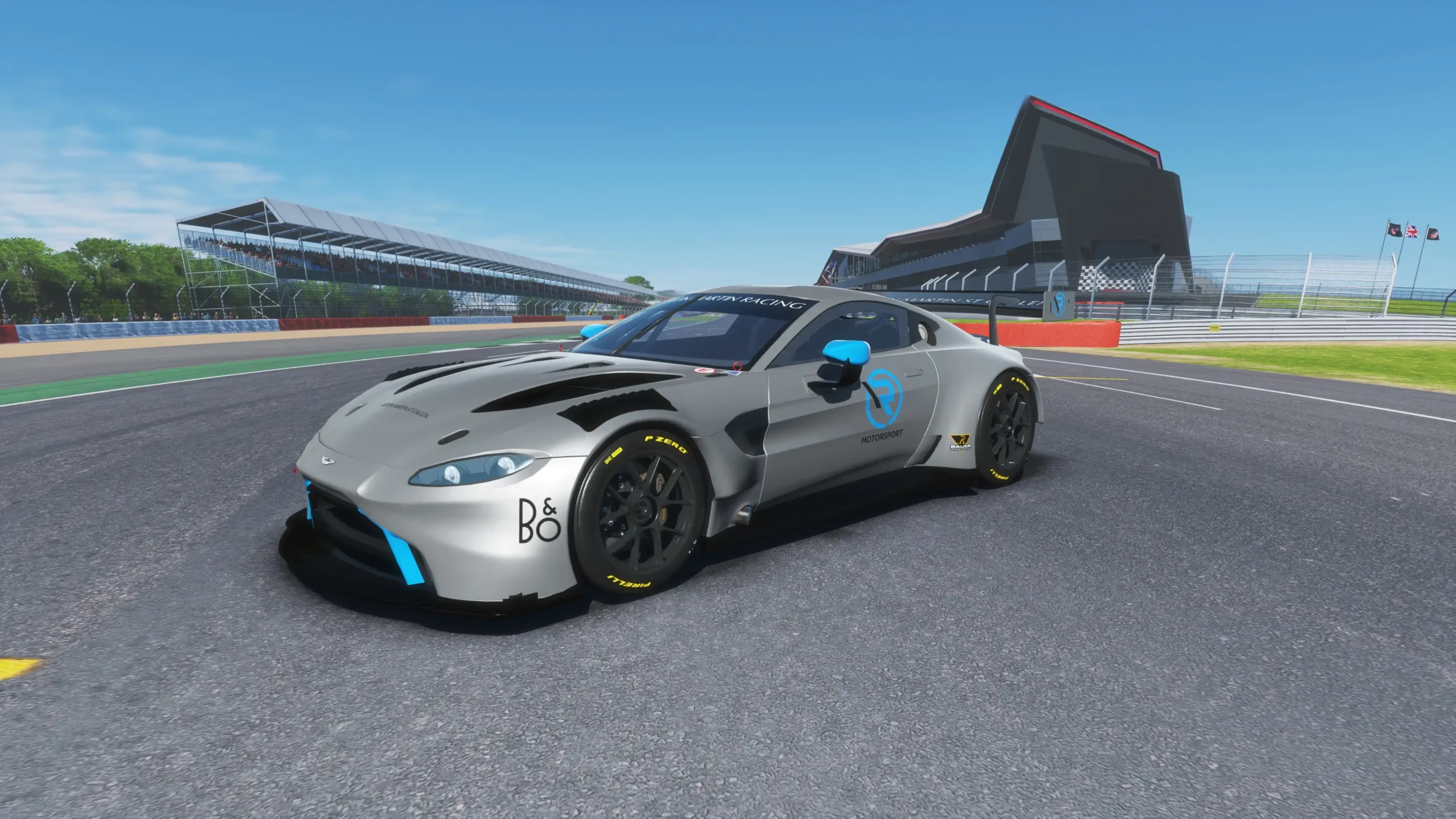 Aston Martin Vantage GT3 racing car speeding on a track in a thrilling video game simulator at Apex Racing Lab.