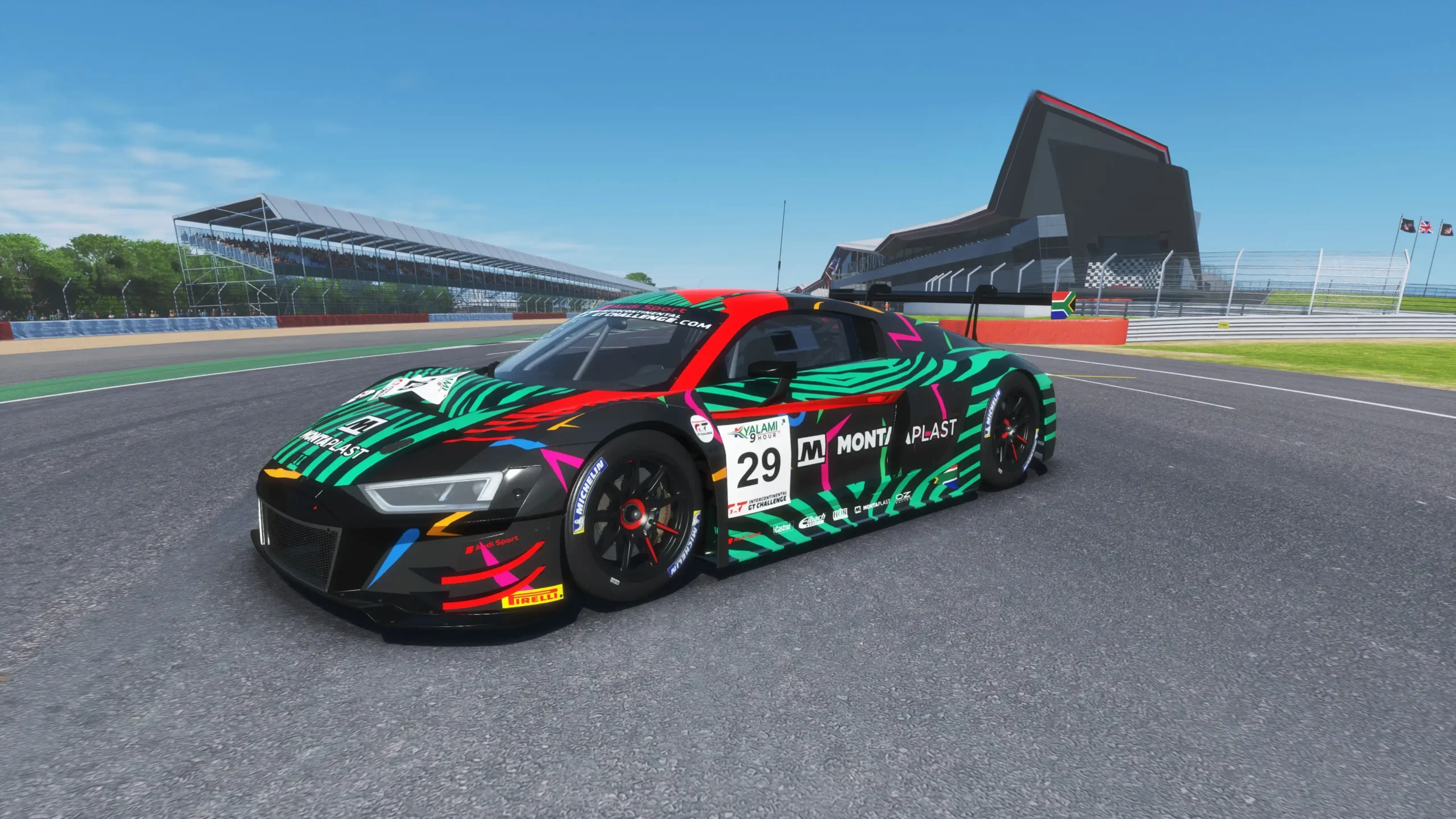 Audi R8 GT3 racing car speeding on a track in a thrilling video game simulator at Apex Racing Lab.